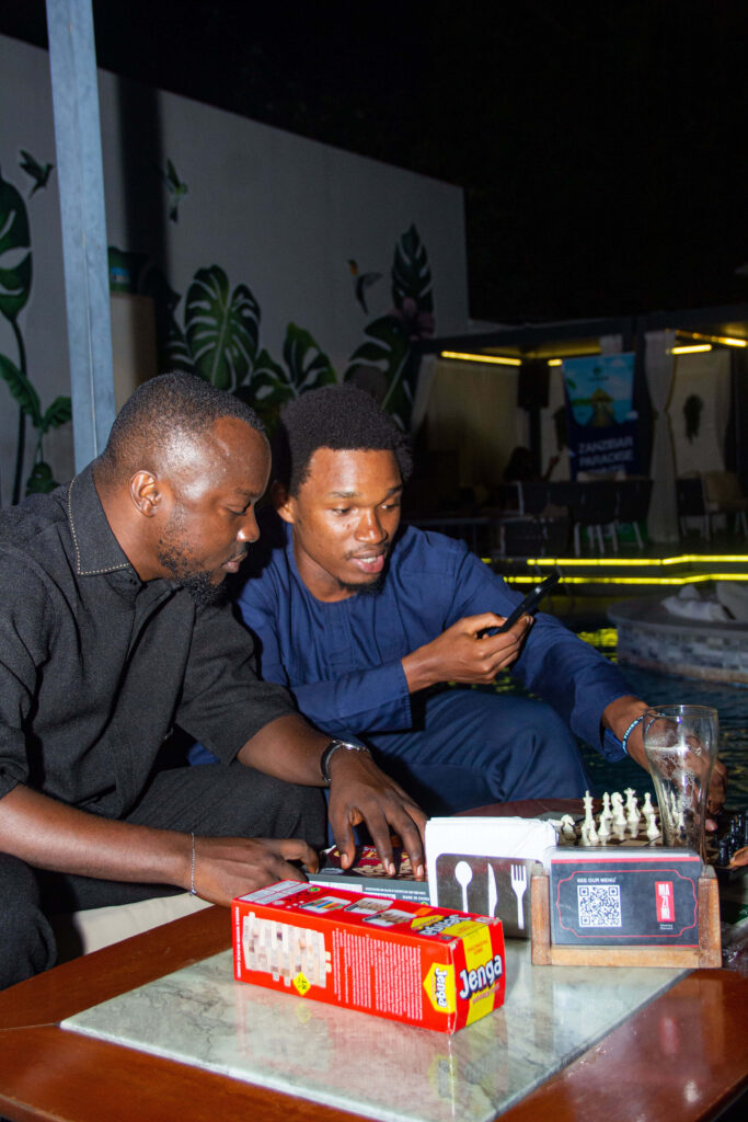 One of the organizers (Kingsley Sintim) and a guest playing a game during the Games Night held while the marathon was ongoing at Mazimi @ The Library Lagos