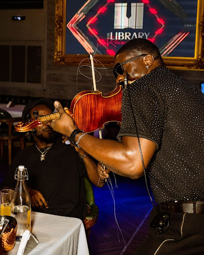 Image of a violinist serenading the scholars during his performance at The Library Lagos