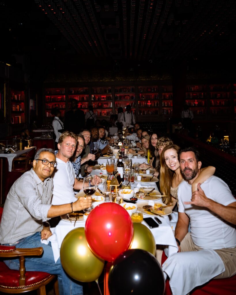 A group of guests at Cee 4 Arena Owerri enjoying a celebratory dinner, wining and dining while watching captivating live performances in the elegant dining space